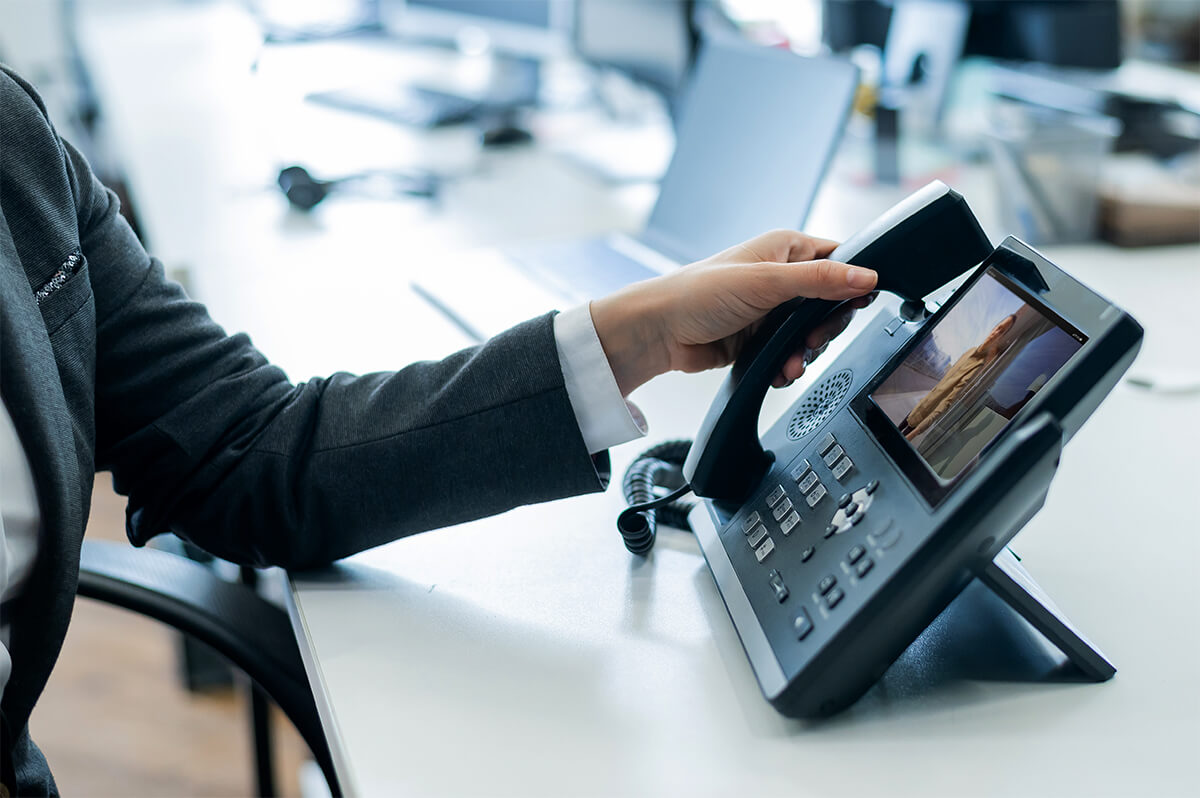 Person using an office phone.