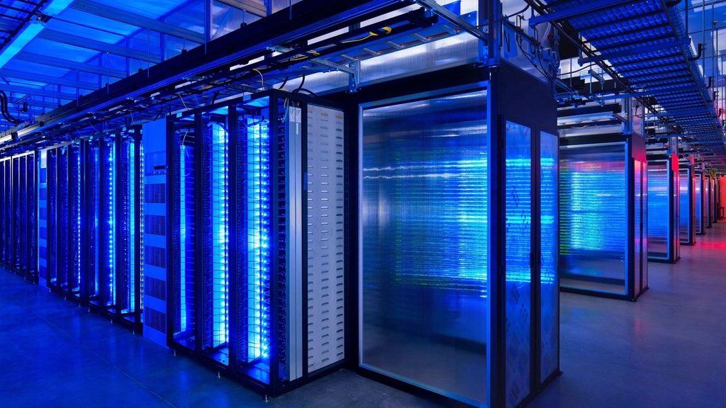 Blue-lit data center aisle with server cabinets.